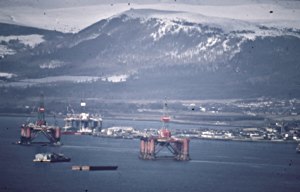 Zoom in Invergordon, plus rigs, and Fyrish hill in the background.