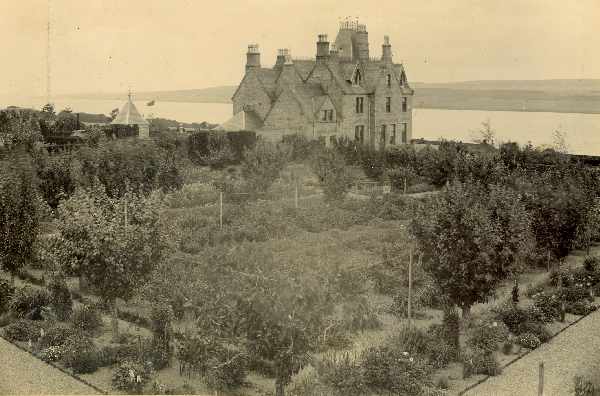 Rear view showing vegetable and fruit garden, with Cromarty Firth and Black Isle in background.