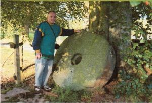 Zoom in The author, Jim Mackenzie, with Thomas Mackenzie’s millstone at Conan House