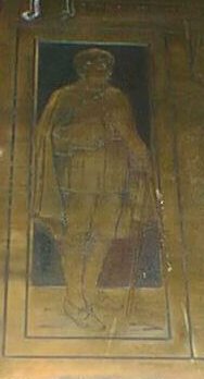Detail from the 1914-1918 plaque - the figure of a scholar with a cloak, book, and stick