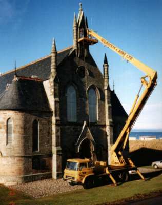 This picture shows the bell, following repair in 1994, being lifted back into position at a height of about 50' above ground.
