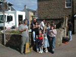 Plowman Family from Achnasheen enjoy a free icecream. The burger stall behind.