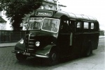 Archie Macrae's bus, JS7693, parked outside Royal Bank in Dingwall. Note cobblestone road.
