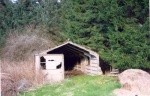 One of the remaining huts with stove.