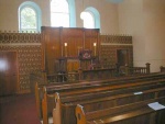 This shows the interior of the church and the impressive pulpit with the emblem of the Burning Bush.