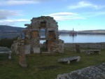 Remains of old chapel with oil rig in the Cromarty Firth.
