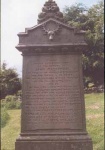 Gravestone in old part of cemetery in memory of John Mackenzie and with his clan crest above.