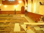 Kenneth Ross, joiner, at work. Insulation in place between joists.