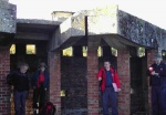 01 Allan Kilpatrick of RCAHMS (in red jacket) pointing out some details in gun emplacement on South Sutor.